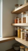 Wooden shelves with glass storage containers filled with dried pasta, grains, legumes and pantry staples, organized kitchen storage solution for home organization and interior design.