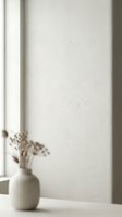 Minimalist ceramic vase with dried flowers on windowsill against textured white wall in soft natural light creating peaceful home decor atmosphere.