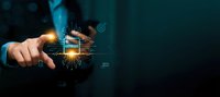 Businessman hand touching glowing digital interface with futuristic holographic technology elements on dark background for business innovation concepts.