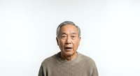 Senior Asian male with gray hair wearing a beige ribbed sweater against a white background. Suitable for healthcare, wellness, and senior lifestyle content.