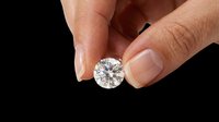 Hand holding a sparkling round cut diamond isolated on transparent background, ready for jewelry, luxury, sticker, print on demand, and t-shirt design use.