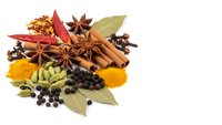 Aromatic spices and herbs collection with cinnamon sticks, star anise, cardamom, bay leaves, peppercorns and turmeric powder isolated on white background.