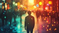 Silhouette of person standing alone against blurred city lights and bokeh effects in orange and turquoise colors creating atmospheric moody urban scene.