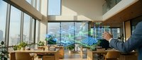 Business professional analyzing holographic data visualization in modern office with city skyline view through floor-to-ceiling windows.