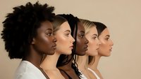 Diverse group of young women in profile showing different ethnicities and skin tones representing beauty, skincare and multicultural unity on neutral background.