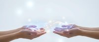 Two pairs of hands reaching toward each other with glowing purple energy or light between them, symbolizing connection, healing, spiritual energy transfer.