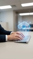 Businessman typing on laptop with glowing cloud computing hologram and security icons in modern office environment for digital transformation concepts.
