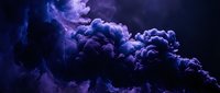 Purple and blue smoke clouds swirling in dramatic formation against dark background creating mystical atmospheric effect for creative projects.