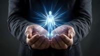 Businessman hands protecting glowing human figure with radiant light rays symbolizing care, support, leadership and human resources management concept.