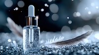 Luxurious serum bottle with dropper on sparkly surface next to delicate feather. Dreamy bokeh lights create magical atmosphere for cosmetic product photography.