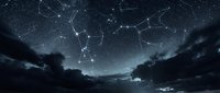 Night sky with constellation patterns connected by glowing lines over silhouetted mountain landscape. Starry astronomy background for astrology and space themes.