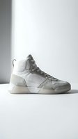 Modern high-top athletic sneaker in white and gray with mesh and suede construction, featuring lace-up closure and chunky sole design for casual wear and streetwear styling.