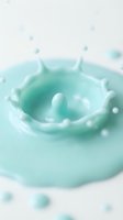 Turquoise liquid splash with crown-like formation and droplets suspended in air, suitable for cosmetics, skincare, and beauty product advertising campaigns.
