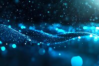 Glowing blue particles flow in abstract wave formation against dark background with bokeh light effects and sparkles creating magical atmosphere.