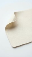 Cream colored textured paper with curved fold creating elegant shadow and depth on white background for design projects.