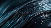 Glowing blue fiber optic strands with bokeh light effects create abstract technology background pattern. Modern digital communication concept.