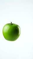 Fresh green apple with water droplets isolated on white background, suitable for healthy eating, nutrition, and food packaging designs.
