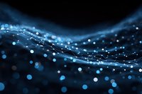 Abstract blue flowing waves with glowing particles and bokeh lights creating dynamic motion effect on dark background for digital design projects.