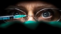 Close-up view of intense blue eyes behind glasses with medical syringe reflection, dramatic lighting creates mysterious medical atmosphere in dark setting.