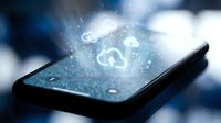 Smartphone displaying glowing cloud computing icons with digital particles and light effects representing data synchronization and wireless connectivity technology.