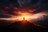 Silhouette of lone person standing on mountain peak against dramatic sunset sky with dark storm clouds and golden sunlight breaking through mountains.