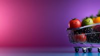 Fresh colorful tomatoes in miniature shopping cart on vibrant pink and purple gradient background with copy space for supermarket and retail design.