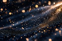 Glowing golden particles and bokeh lights on dark background with shimmering wave pattern creating magical atmospheric effect.