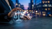 Professional businessman protecting digital justice scales icon with hand gesture in modern city environment for legal technology and law firm services.