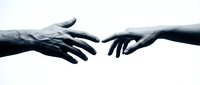 Two hands reaching toward each other in helping gesture on white background, symbolizing connection, support, teamwork and human cooperation.
