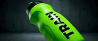 Neon green sports drink bottle with black text on dark textured background, suitable for beverage marketing and advertising campaigns.