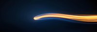 Abstract glowing orange and blue light trails flowing smoothly against dark background creating dynamic motion effect, suitable for technology and innovation designs.