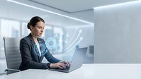 Professional businesswoman working on laptop with digital holographic interface in modern office environment for technology and innovation concepts.