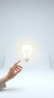 Hand reaching toward glowing light bulb symbolizing innovation, creativity, and bright ideas for business solutions and entrepreneurial concepts.