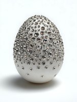 Luxury white Easter egg decorated with sparkling rhinestones and crystals on white background for holiday celebrations and elegant decor.