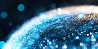 Sparkling blue and gold glitter particles create cosmic atmosphere with bokeh effect and blurred background, macro photography for festive designs.
