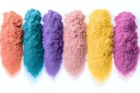 Colorful cosmetic pigment powder swatches in coral, turquoise, purple, pink, yellow and magenta shades arranged in neat rows on white background, isolated makeup texture.