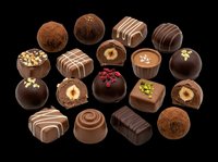 Assorted chocolate truffles and bonbons isolated on transparent background. Premium confectionery collection featuring dark chocolate, milk chocolate, and cocoa-dusted spheres with decorative toppings. Ready for culinary design, food packaging, recipe blogs, menus, and print-on-demand products.