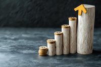 Stacked wooden cylinders forming ascending graph with golden coins and arrow, representing financial growth and investment success on dark background.