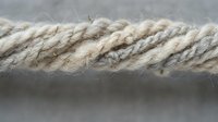 Natural hemp rope close-up showing twisted fibers and organic texture for nautical, crafting, and rustic design projects.