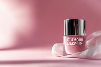 Pink nail polish bottle on soft silk fabric against rosy background with gentle shadows, luxury cosmetic product photography for beauty and fashion marketing.