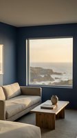 Coastal bedroom interior with navy walls, upholstered sofa, wooden coffee table, and large window overlooking ocean cliffs at sunset. Minimalist design for home decor and hospitality projects.