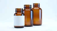 Amber glass pharmaceutical bottles with white label isolated on white background for medical packaging and healthcare product design.
