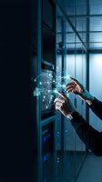 Businessman hands touching holographic digital interface in modern data center with futuristic technology network connections and glowing elements.