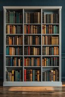 Classic white wooden bookshelf filled with vintage hardcover books in various colors against dark teal wall, standing on hardwood flooring with dramatic lighting.
