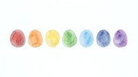 Watercolor painted eggs in rainbow colors arranged in a row on white background, isolated and ready for Easter designs, greeting cards, and seasonal projects.