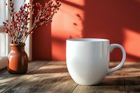 White ceramic coffee mug on wooden table with red dried flowers in vase and dramatic window light shadows creating minimalist morning atmosphere for lifestyle content.