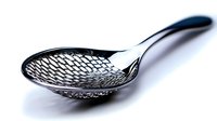 Elegant perforated metal serving spoon with curved handle and mesh bowl design on white background, ideal for modern kitchen accessories.