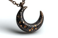 Textured black crescent moon pendant with copper accents on chain necklace against white background, macro jewelry photography showing intricate details.
