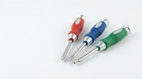 Three colorful ballpoint pens with ergonomic grips in red, blue and green arranged on white background for office supplies and stationery design.