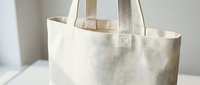 Natural cotton canvas tote bag with handles on white background, eco-friendly reusable shopping bag isolated for sustainable lifestyle and zero waste design.